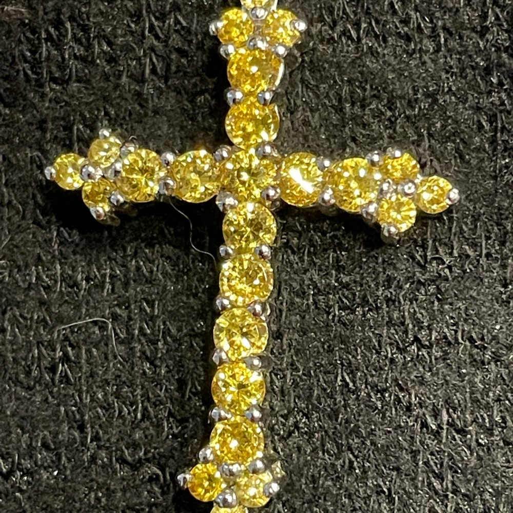 Cross of sparkling yellow crystal-like stones 1-1/4”.  No missing sets.